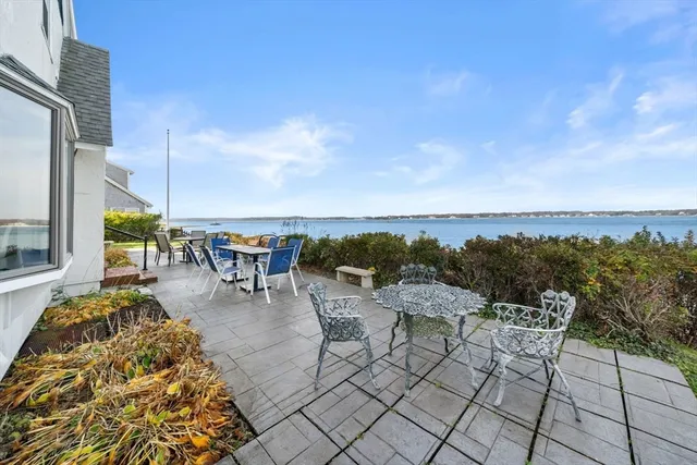 a spacious bathroom with a granite countertop sink a mirror and a shower