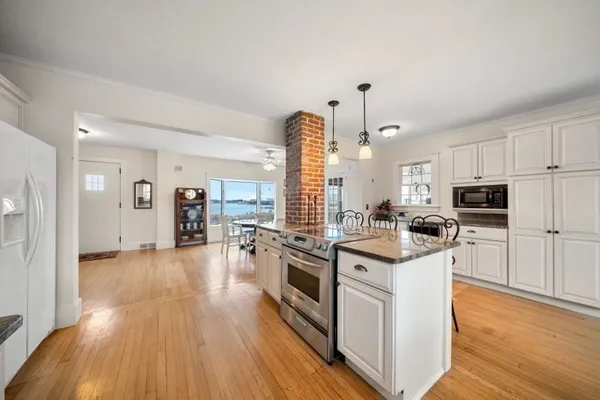 a kitchen with stainless steel appliances and white cabinets