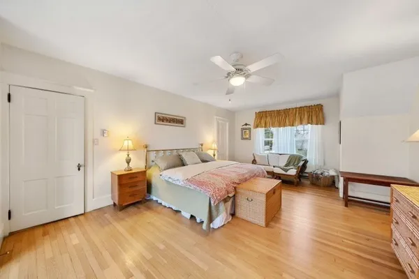 a bedroom with two beds and wooden floor