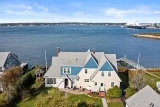 an aerial view of a house with outdoor space swimming pool and ocean view
