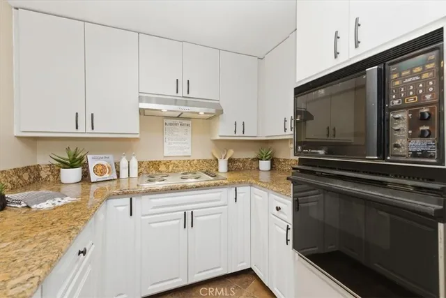 a bathroom with a granite countertop sink a mirror and with window