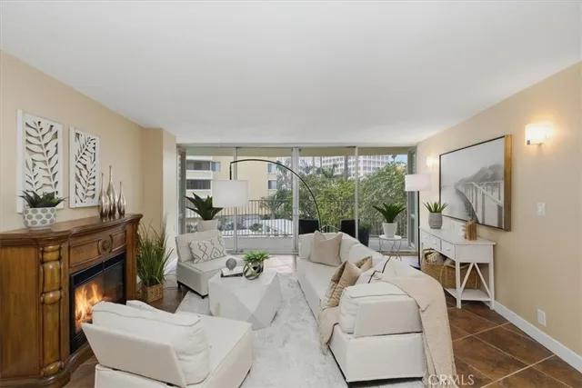a living room with furniture a large window and a fireplace
