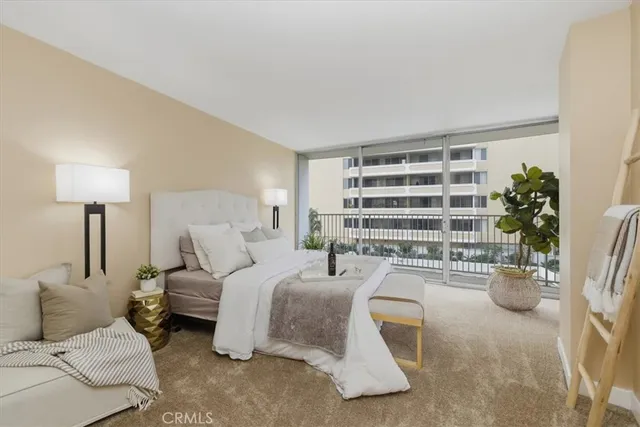 a bedroom with furniture and a large window