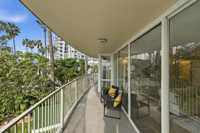 a view of a balcony with chairs and table