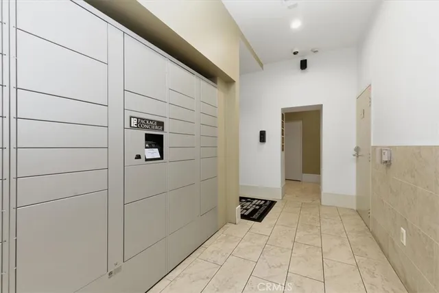 a living room with furniture a large window and work space