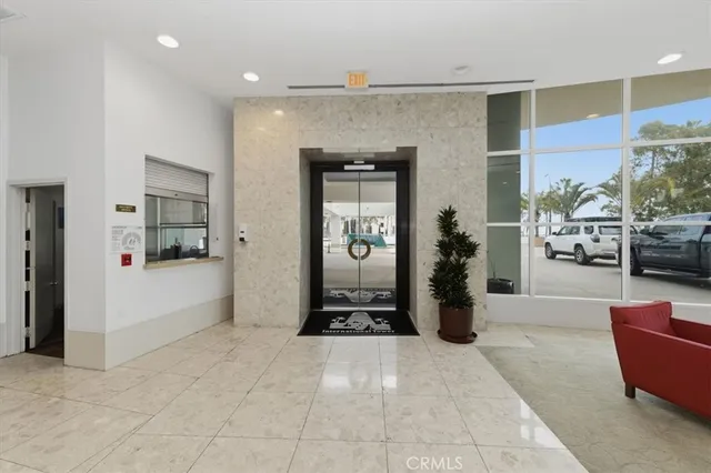 a living room with furniture and large windows