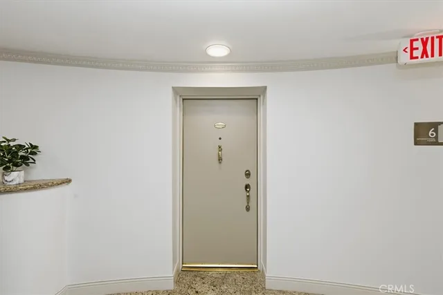 a view of a hallway with table and a potted plant