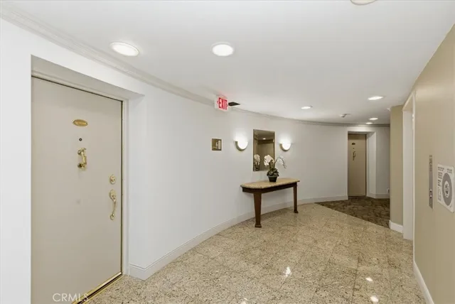 a dining room with furniture and a potted plant