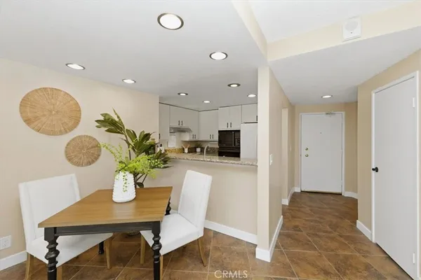 a kitchen with granite countertop a refrigerator and a sink