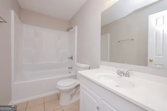 a bathroom with a sink toilet vanity and shower