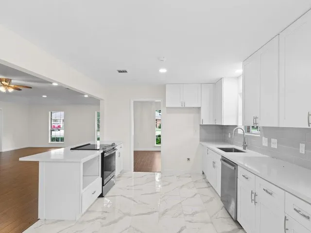 a kitchen with a sink stove and refrigerator