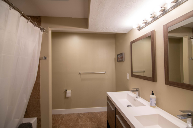 646 East 1400th Street North Mapleton, UT 84664 - Photo 48 of 78 Bathroom featuring a dual vanity with integrated sinks, framed mirrors, and a multi-bulb light fixture