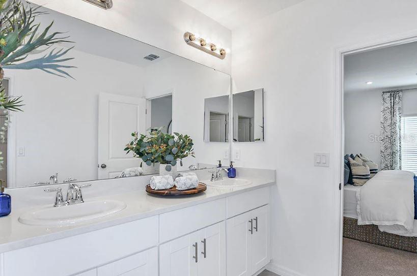 13815 Sawmill Street Parrish, FL 34219 - Photo 17 of 25 a bathroom with a double vanity sink and a mirror