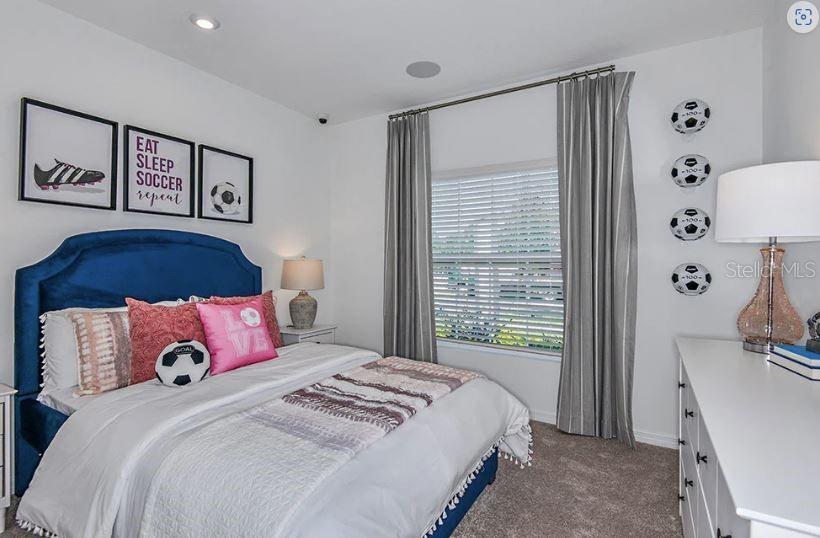 13815 Sawmill Street Parrish, FL 34219 - Photo 7 of 25 a bedroom with a large bed and a dresser