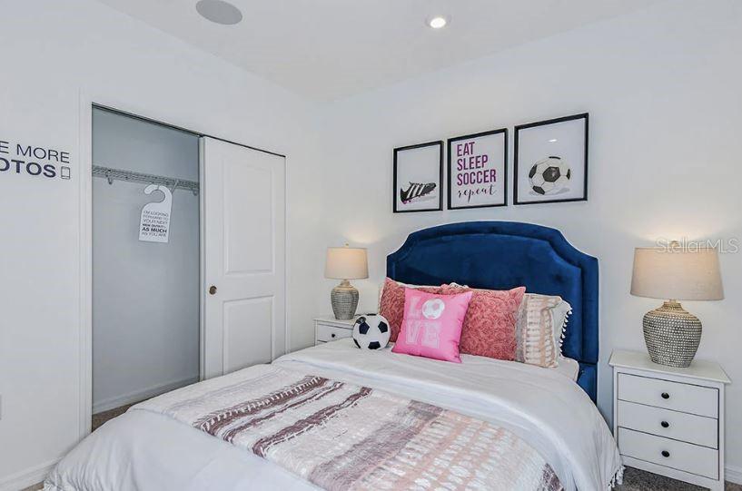 13815 Sawmill Street Parrish, FL 34219 - Photo 8 of 25 a bedroom with a bed and a lamp on dresser
