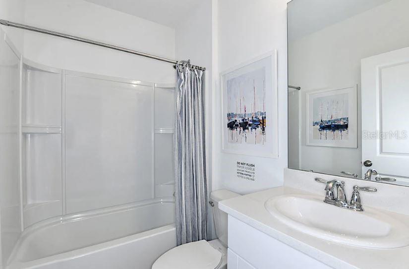 13815 Sawmill Street Parrish, FL 34219 - Photo 10 of 25 a bathroom with a sink toilet and shower