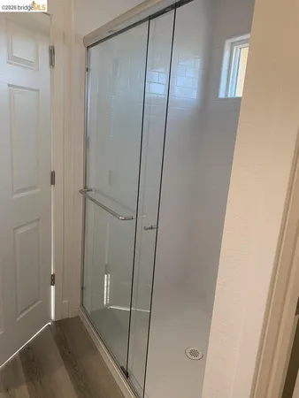 a bathroom with a glass shower door