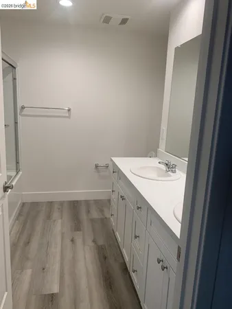 a bathroom with a sink a mirror and a shower