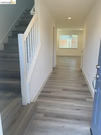 a view of entryway and hall with wooden floor
