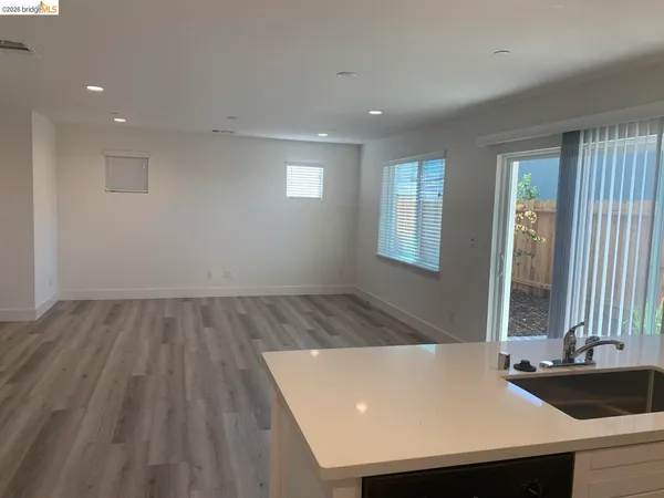 a view of a room with pool table and two windows