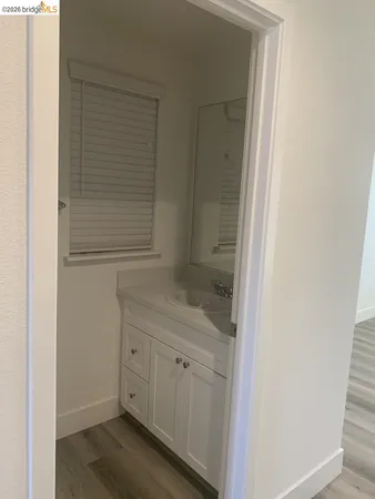 a bathroom with a granite countertop sink and vanity