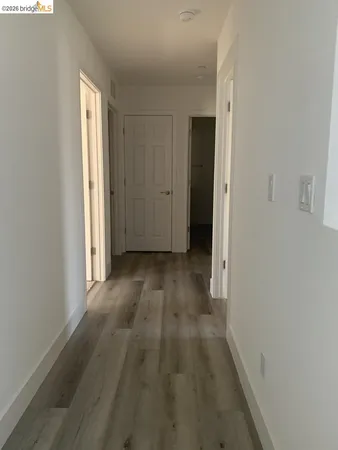 a view of hallway with wooden floor