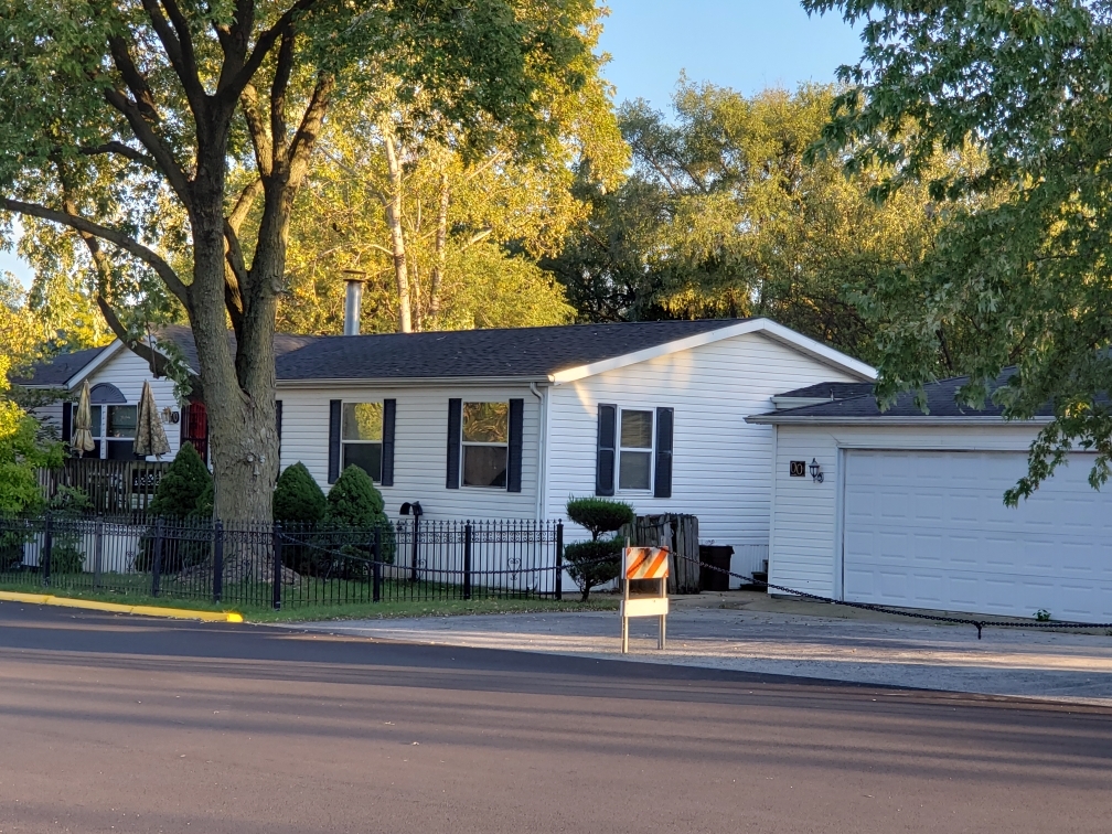 7500 Elmhurst Road Des Plaines, IL 60018 - Photo 1 of 14 a front view of a house with a yard and garage