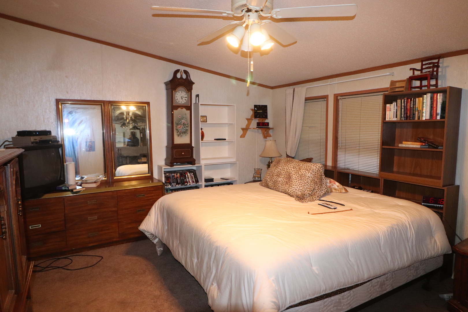 7500 Elmhurst Road Des Plaines, IL 60018 - Photo 11 of 14 a bedroom with a bed and dresser with mirror