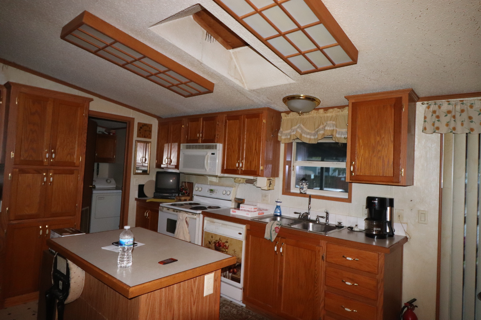 7500 Elmhurst Road Des Plaines, IL 60018 - Photo 7 of 14 a kitchen with stainless steel appliances granite countertop a sink refrigerator stove and microwave