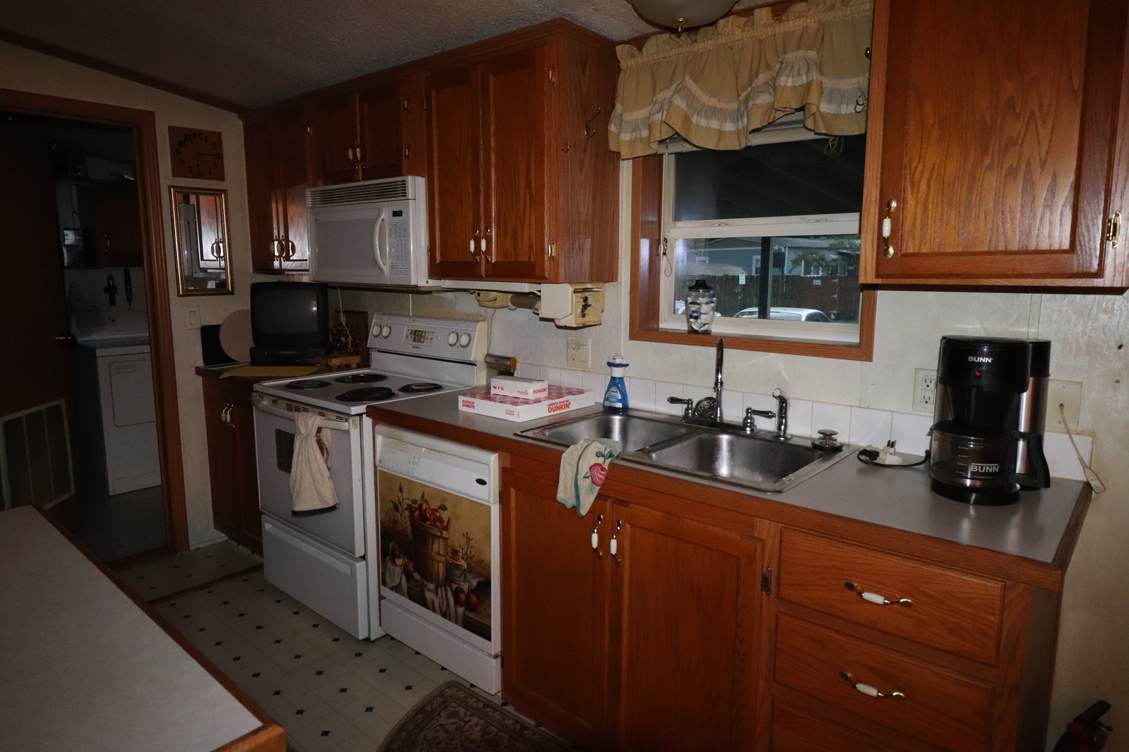 7500 Elmhurst Road Des Plaines, IL 60018 - Photo 8 of 14 a kitchen with granite countertop a sink a stove and cabinets