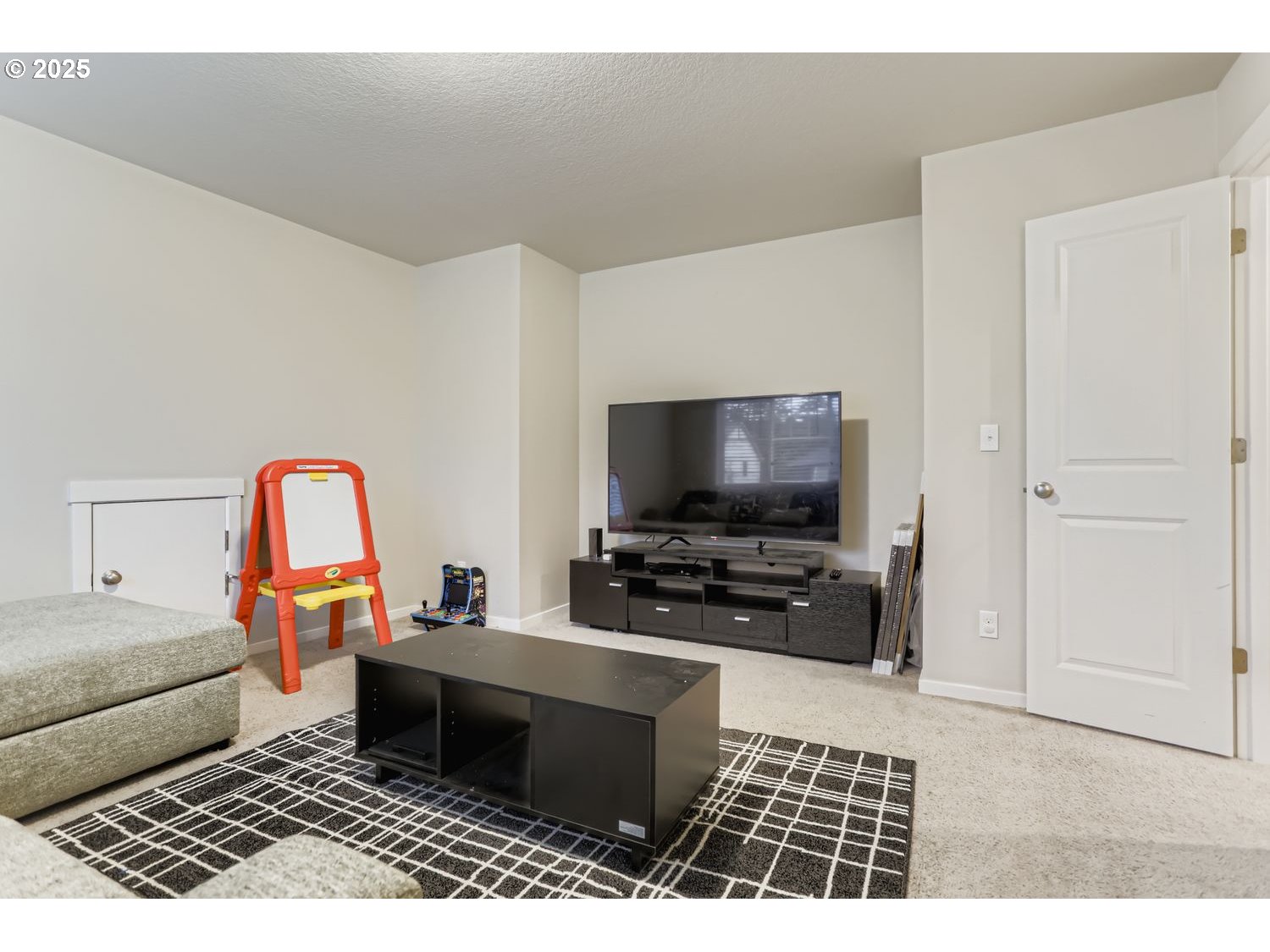 15295 Southeast Flavel Street Portland, OR 97236 - Photo 20 of 26 a living room with furniture and a flat screen tv