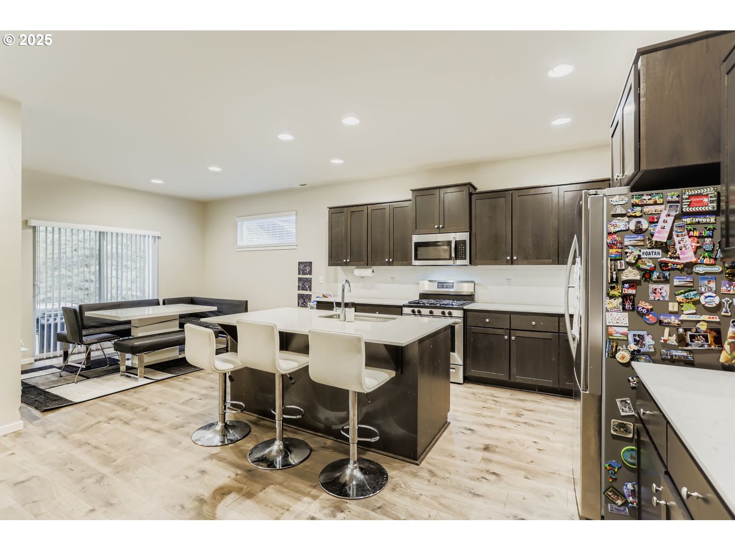 15295 Southeast Flavel Street Portland, OR 97236 - Photo 2 of 26 a kitchen with stainless steel appliances kitchen island granite countertop a sink and cabinets