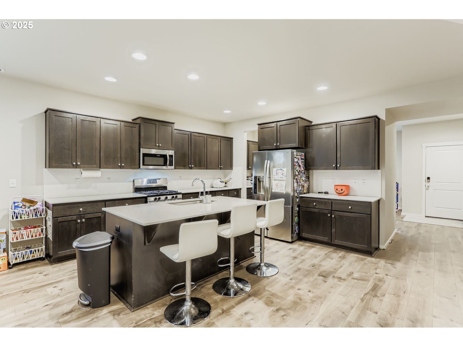15295 Southeast Flavel Street Portland, OR 97236 - Photo 3 of 26 a kitchen with stainless steel appliances kitchen island granite countertop a sink and a stove