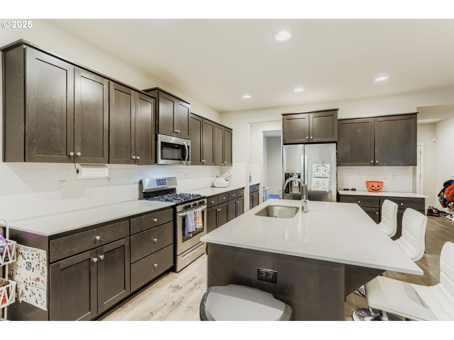 15295 Southeast Flavel Street Portland, OR 97236 - Photo 4 of 26 a kitchen with granite countertop a sink counter top space appliances and cabinets