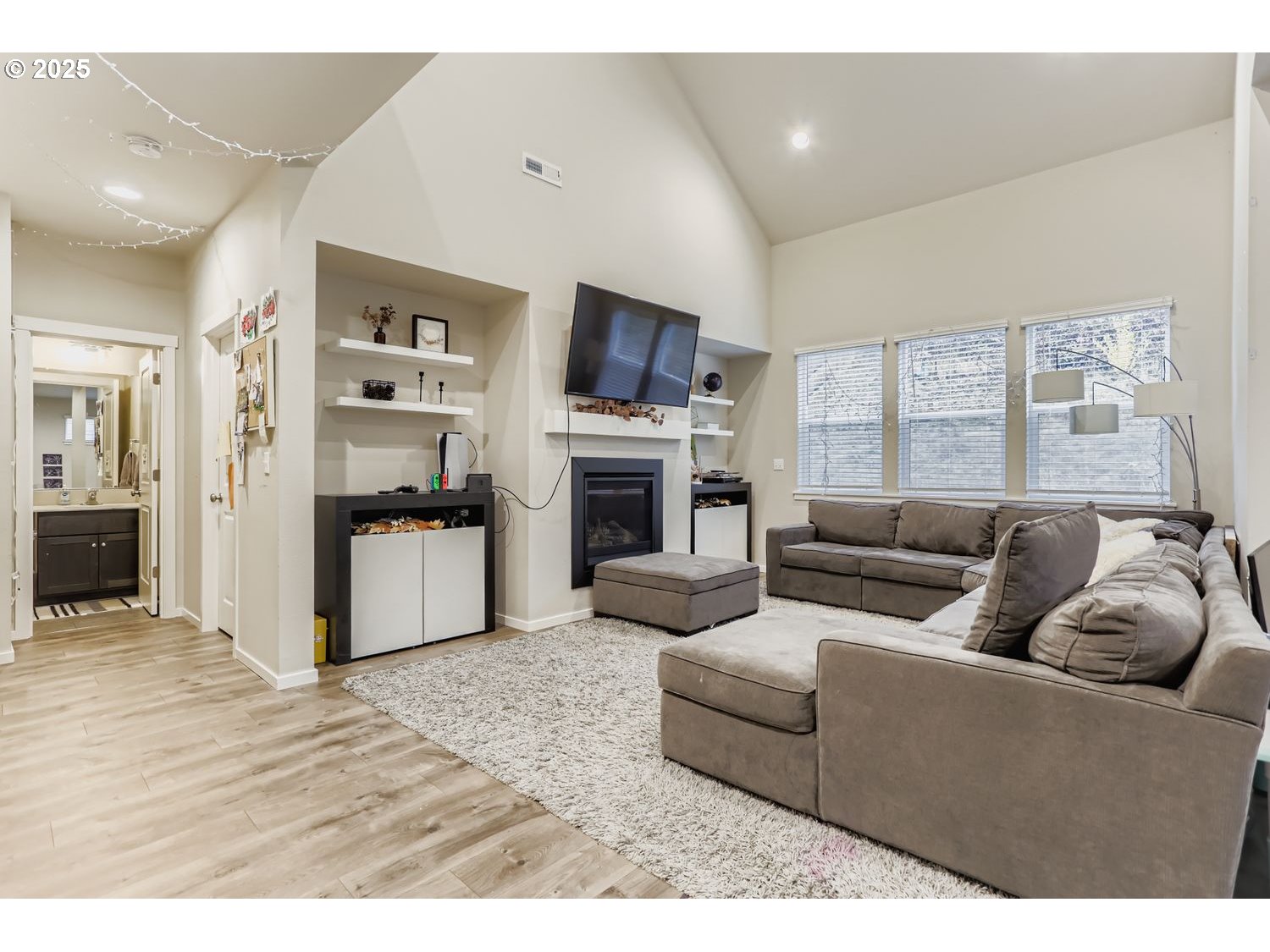 15295 Southeast Flavel Street Portland, OR 97236 - Photo 5 of 26 a living room with furniture flat screen tv and a fireplace