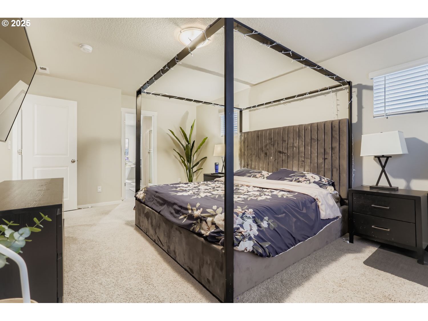 15295 Southeast Flavel Street Portland, OR 97236 - Photo 10 of 26 a bed sitting in a bedroom next to a window