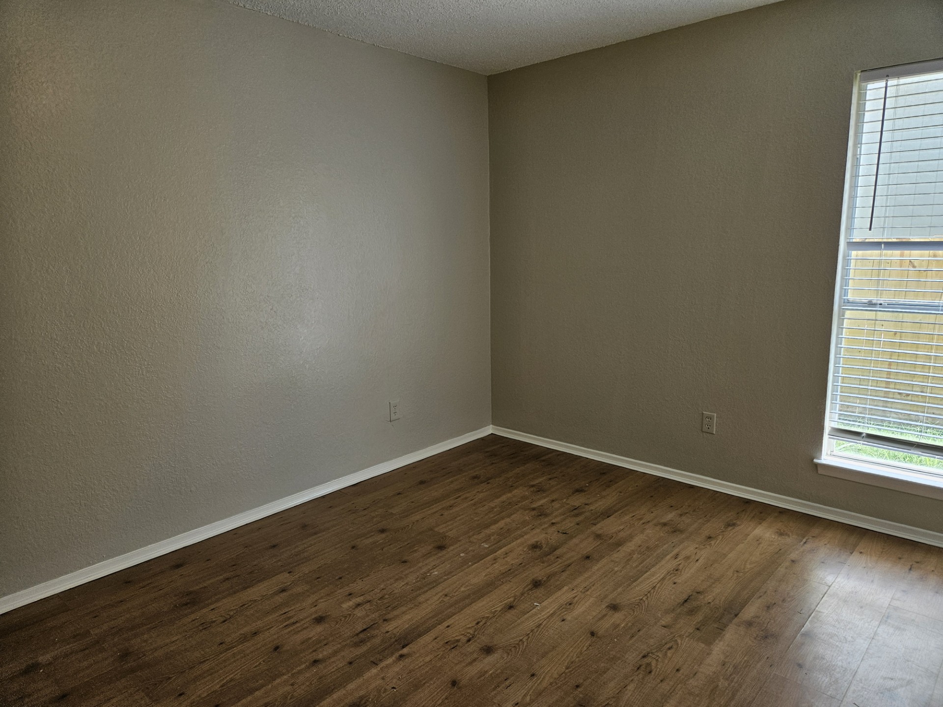 805 Lexington Road, Unit B Elgin, TX 78621 - Photo 4 of 11 Rich wood flooring adds warmth to this versatile room, ready for your personal touch.