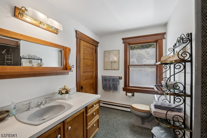 833 Berkshire Valley Road Wharton, NJ 07885 - Photo 21 of 48 a bathroom with a toilet sink and mirror
