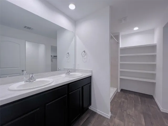 a bathroom with a sink a vanity and a mirror
