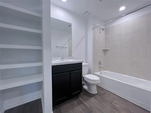 a bathroom with a sink a toilet a shower and a mirror