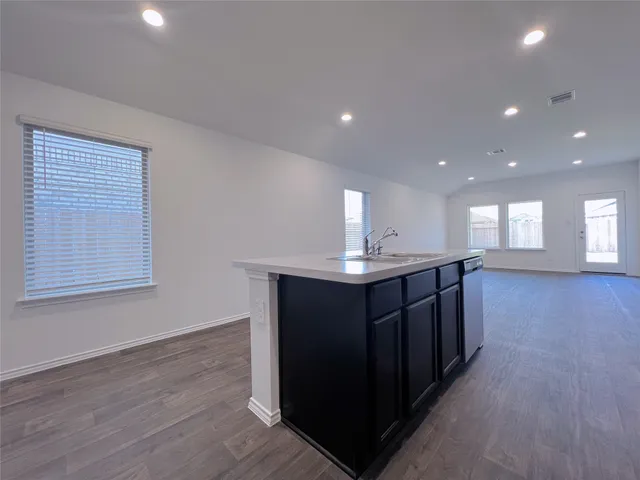 a kitchen with wooden cabinets and sink