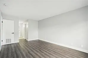 a view of an empty room and wooden floor