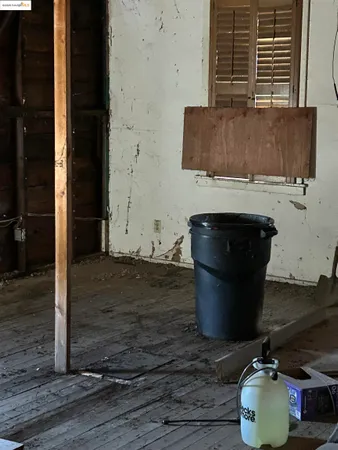 a room with water heater and wooden floor
