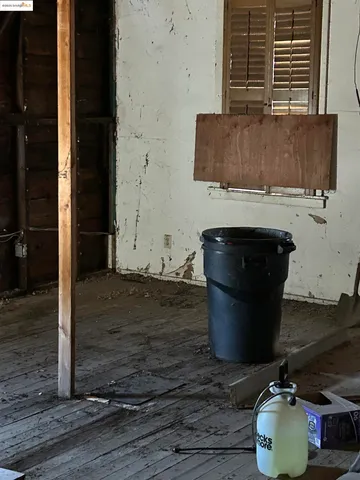 a room with water heater and wooden floor
