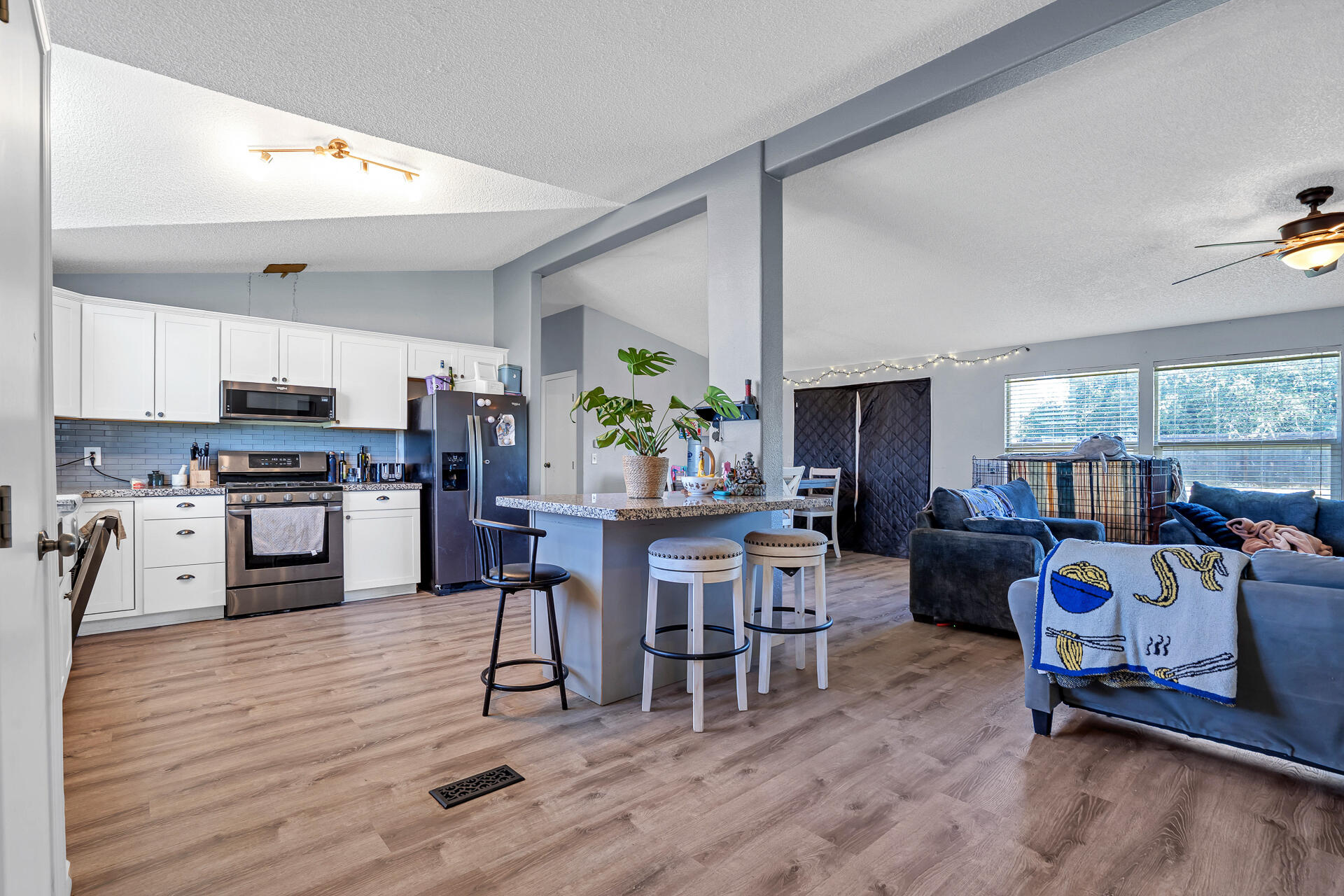 27127 Swede Creek Road Oak Run, CA 96069 - Photo 11 of 33 a kitchen with stainless steel appliances a dining table chairs stove refrigerator and cabinets