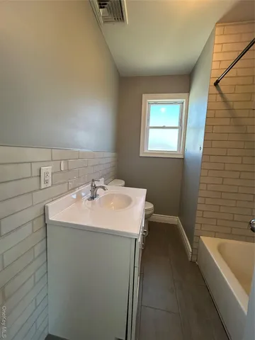 a bathroom with a sink a bathtub and a shower