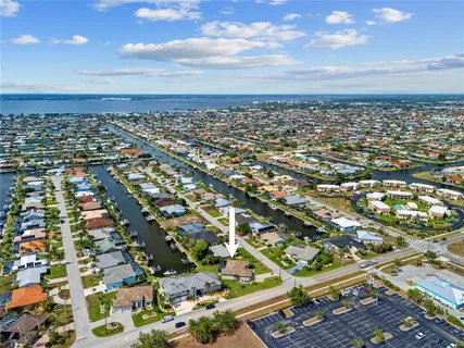 a view of a house with a backyard and plants