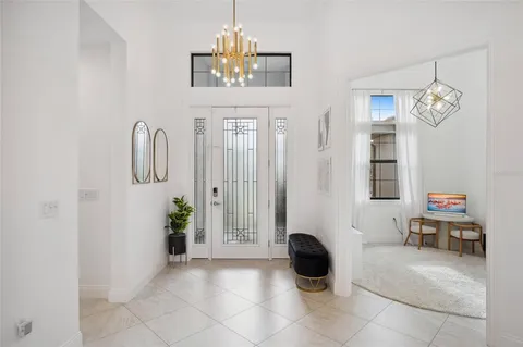 a view of a living room kitchen and a large window