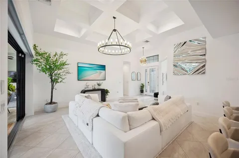 a kitchen with stainless steel appliances kitchen island granite countertop a dining table chairs and a refrigerator