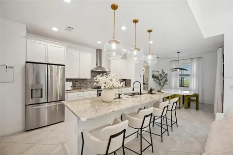 a kitchen with a sink counter top space appliances and cabinets